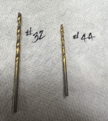 I use #44 drill to pass through the bottom of the joiner and out the top to identify the location of the bolt.  I only drill one 1/2 at a time, much like the wing.  This allows for everything to fit tightly and securely without misalignment.