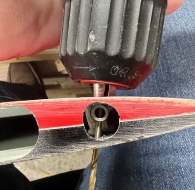 Dremel a hole near the end of the torque rod at the root to allow access to the end of the troque rod.  Next use a #44 drill to drill through the torque rod through the bottom skin to position a hole for the 4-40 bolt that will actuate the aileron.