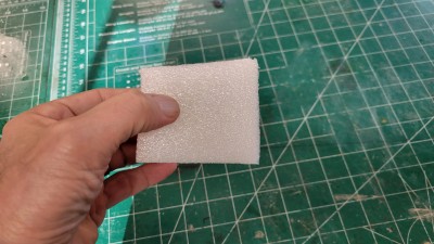 I use a piece of foam cut at an angle to hold in the battery plate until the glue hardens.