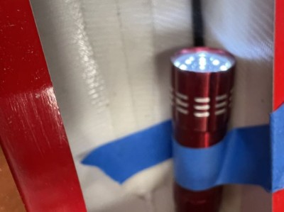 I tape a flashlight to the fuselage to provide light during the install process.